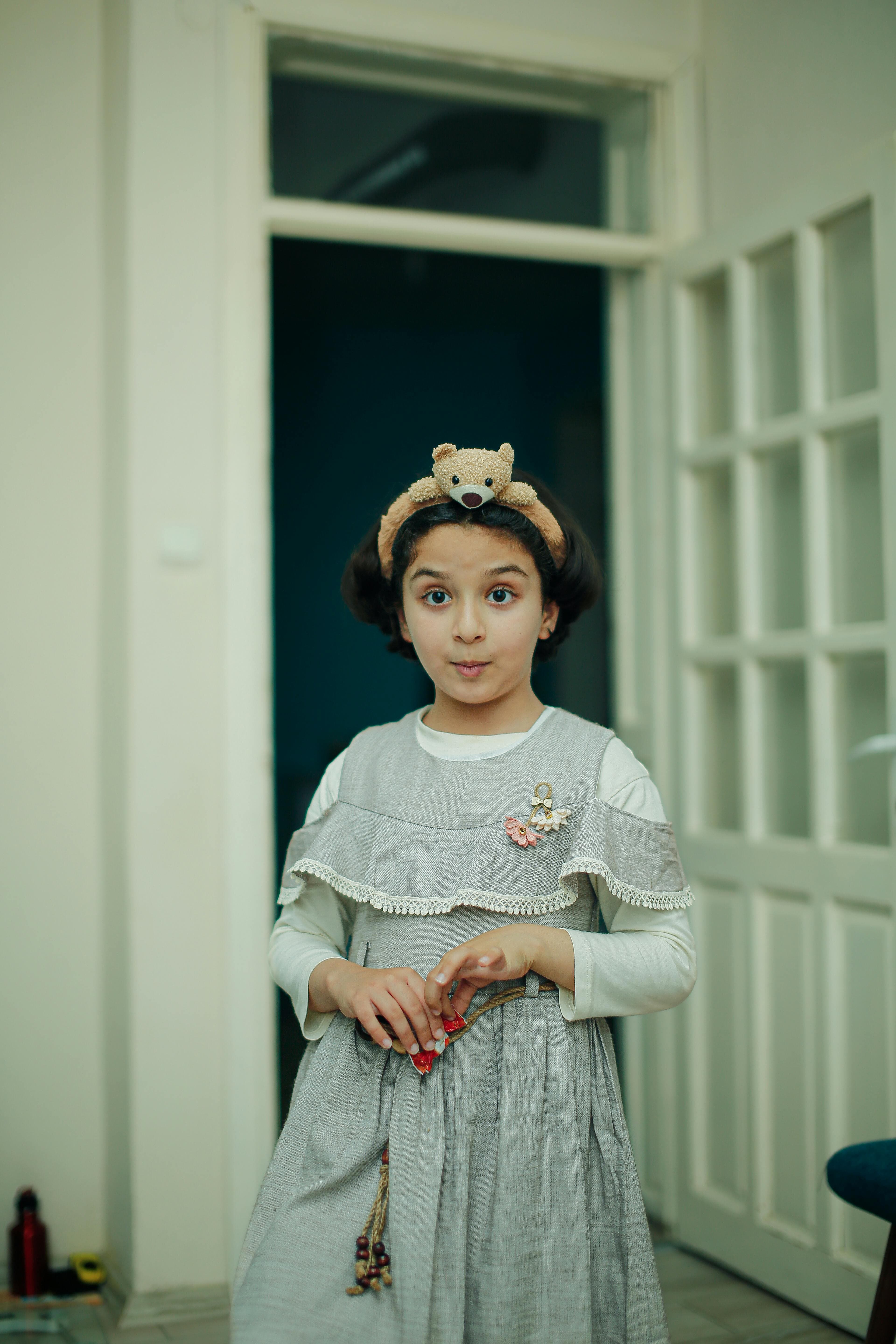 Child wearing a soft grey outfit